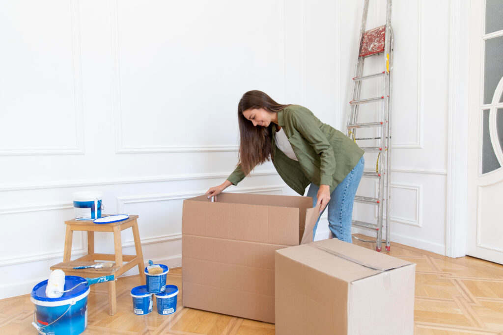 woman cleaning in room with moving boxes